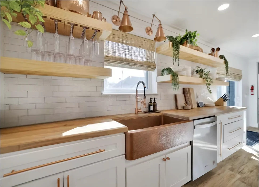 Copper farmhouse sink with subway tile and open wooden shelves